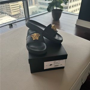 AUTHENTIC Gucci Slides Black w gold medallion. Slightly used.